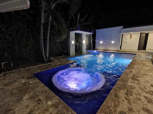 a pool in the middle of a yard at night at Casa condominio santa ana in Flandes