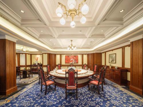 a large room with a large table and chairs at Shanghai Donghu Hotel - Shanghai Style Garden House in Shanghai