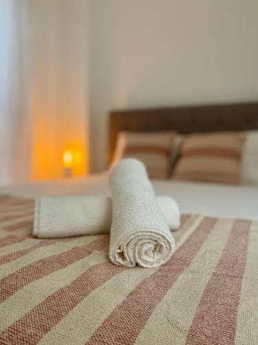 a towel sitting on top of a bed at Casa da Aldeia in Bensafrim