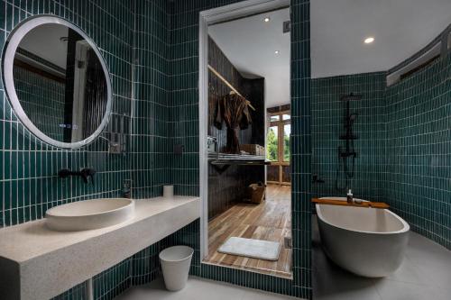 a bathroom with two sinks and a tub and a mirror at Clan Living - The Lovers Ubud Private Villas in Ubud