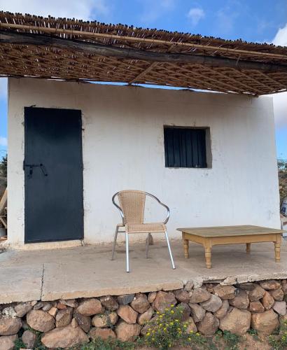 a chair and a bench in front of a building at Animal Service Center in Nador