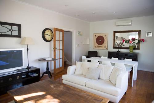 a living room with a white couch and a tv at Apartment 88 in Greytown