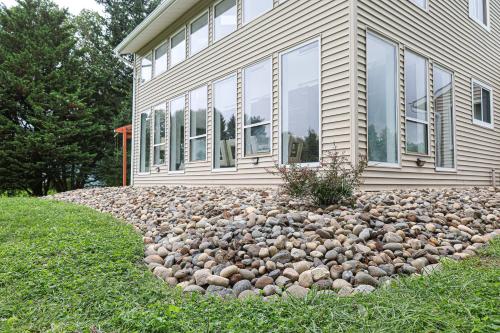 a house with a rock garden in front of it at Beautiful home with mountain top views with an EV and NEMA connection!! in Poughkeepsie
