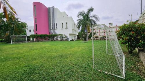 a soccer goal in a field in front of a building at Hotel Hacienda del Rio Oaxtepec in Pantitlán