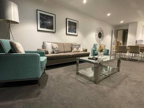 a living room with a couch and a coffee table at Premier 3 Bedroom Apartment in Southbank in Melbourne