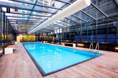 a large swimming pool in a building with a glass ceiling at Premier 3 Bedroom Apartment in Southbank in Melbourne
