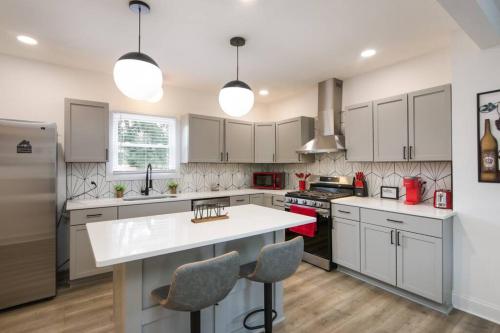 a kitchen with white cabinets and a white counter top at 5th Street Retreat Private Home OSU, Short North in Columbus