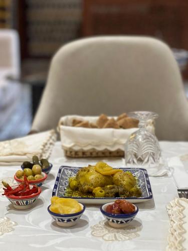 a table with a plate of food on a table at Riad Safia in Rabat