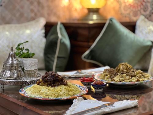 a table with two plates of food on it at Riad Safia in Rabat