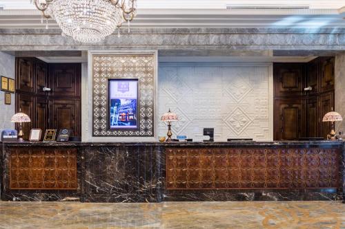 a bar in a lobby with a chandelier at Shanghai Donghu Hotel - Shanghai Style Garden House in Shanghai
