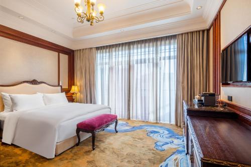 a hotel room with a bed and a television at Shanghai Donghu Hotel - Shanghai Style Garden House in Shanghai