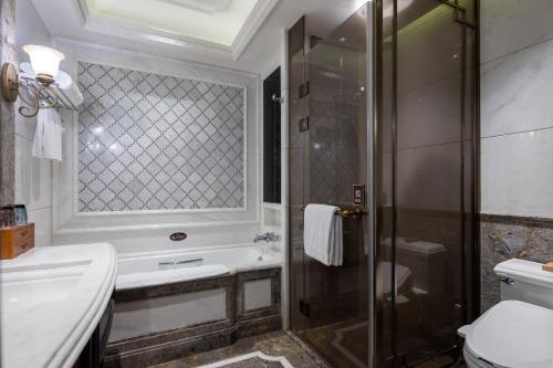 a bathroom with a shower and a sink and a toilet at Shanghai Donghu Hotel - Shanghai Style Garden House in Shanghai