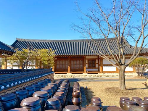 a row of seats in front of a building at Hanok Stay Namwonyechon by Kensington in Namwon