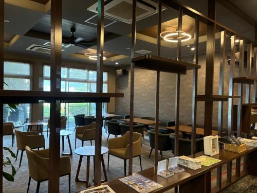 a restaurant with tables and chairs in a room at Fukusenka in Ukiha