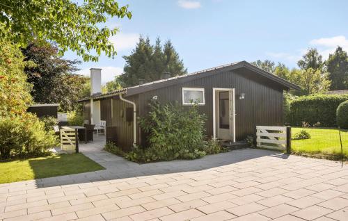 a small shed with a patio in front of it at Beautiful Home In Dronningmølle in Dronningmølle