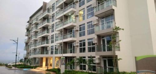 a large white apartment building with a lot of windows at Boracay Condo 1, Ocean Garden Villa Boracay Newcoast in Boracay