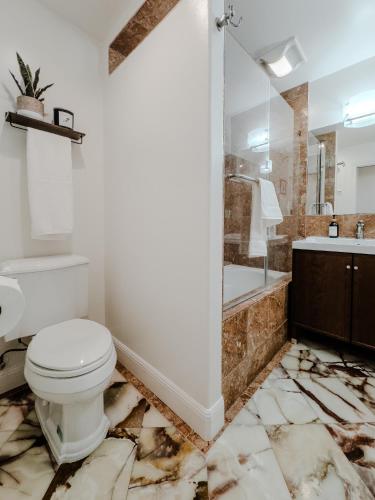 a bathroom with a toilet and a sink and a tub at Serene Escape 2BD Private Patio & Firepit near Stanford in Menlo Park