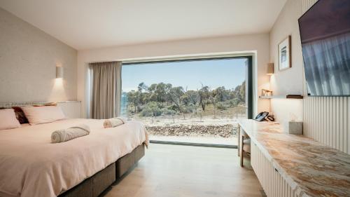 a bedroom with two beds and a large window at Rumi On Louth in North Shields
