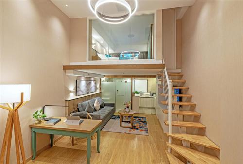 a living room with a staircase and a couch at Mehood Lestie, Xiamen Zhongshan Road Pedestrian Street in Xiamen