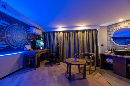 a room with a desk and a table and a computer at Mehood Lestie, Xiamen Zhongshan Road Pedestrian Street in Xiamen