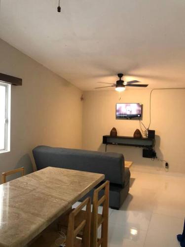 a living room with a couch and a ceiling fan at casa jireh in Santa Cruz Huatulco