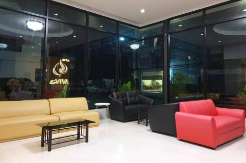 a lobby with couches and chairs in a store at La VIVA Hotel in Buriram
