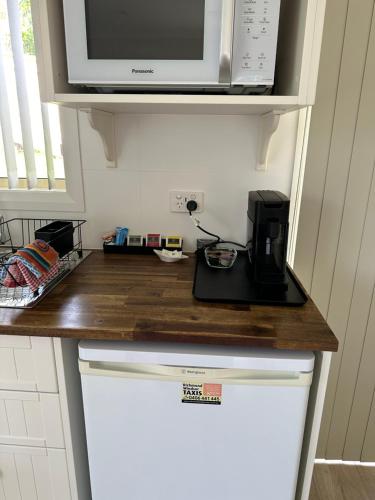 a kitchen counter with a microwave and a coffee maker at Blueberry Hills On Comleroy Farmstay - Self-Contained Cottages in Kurrajong