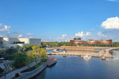 a view of a river with boats in a city at JW Marriott Shanghai Fengxian in Shanghai