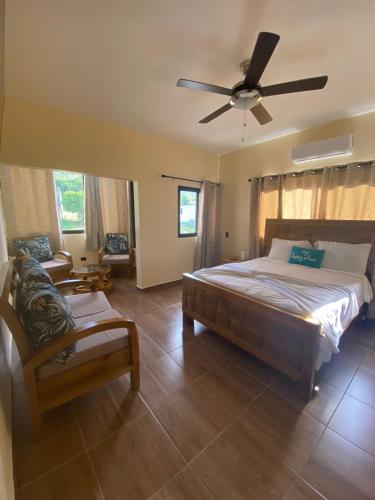 a bedroom with a bed and a ceiling fan at VillaLunaCaridad in Jarabacoa