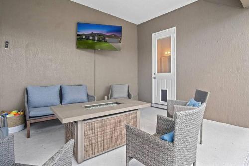 a living room with a table and chairs at Luxury Heated Pool Home, Hot tub, King bed suite in Lakeland