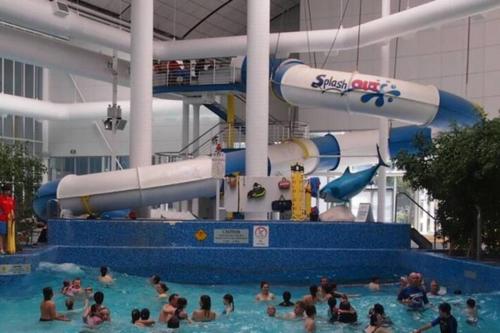 a group of people in a swimming pool at a water park at Boutique Art Deco Apt, Beach, Park, Shops, Cafes F1 in Melbourne