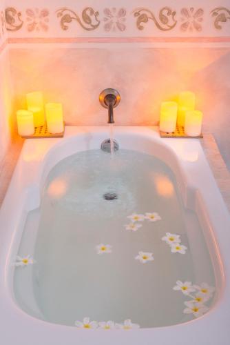 a bath tub with a faucet in a bathroom at Hacienda Santa Cruz Merida in Mérida