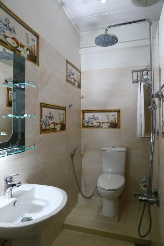 a bathroom with a toilet and a sink at City Nest Inn in Kandy