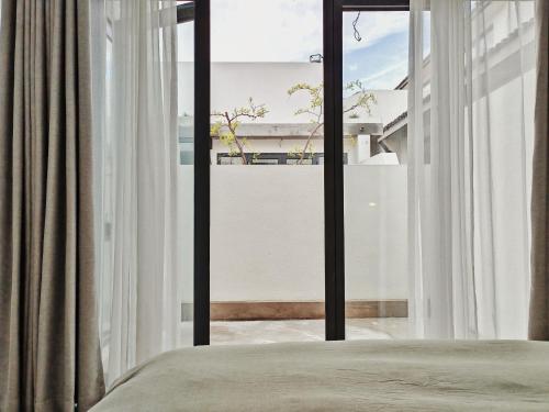 a bedroom with a bed and a large window at Beijing Wuji Inn - The Great Wall of China Huanghuacheng in Beijing