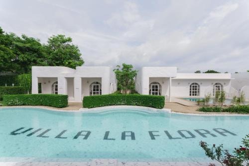 a swimming pool in front of a villa la fl inn at Villa La Flora Kanchanaburi in Ban Hua Hin