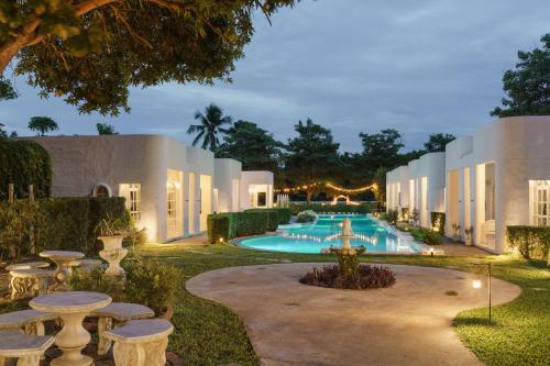 an exterior view of a villa with a swimming pool at Villa La Flora Kanchanaburi in Ban Hua Hin