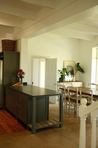 a kitchen and dining room with a table and chairs at Gabriëlskloof Farm House in Botrivier