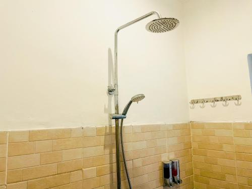 a shower with a shower head in a bathroom at Nusa Penida Homestay in Nusa Penida