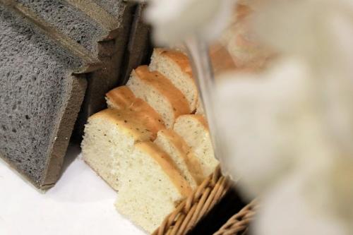 a loaf of bread in a basket with a knife at Boda Hotel in Taichung