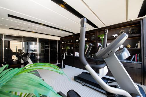 a fitness room with a gym with a treadmill at Boda Hotel in Taichung