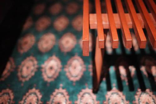 a close up of the back of a wooden bench at SENSE Beppuwan in Hiji
