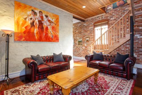 a living room with two leather couches and a table at Local Living in South Fremantle