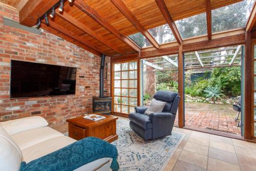 a living room with a couch and a chair at Local Living in South Fremantle