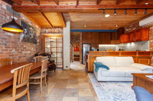 a living room with a white couch and a kitchen at Local Living in South Fremantle