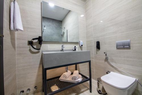 a bathroom with a sink and a toilet at V Center Hotel in Trabzon