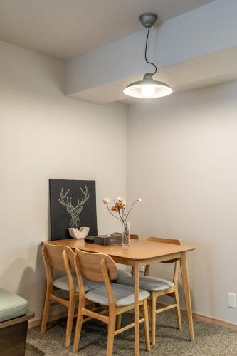 a dining room with a table and chairs at Apartment Hotel 11 Shinsaibashi in Osaka