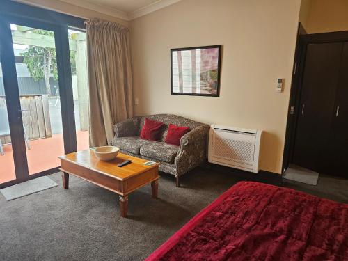 a living room with a couch and a coffee table at Gateway Motor Inn in Masterton