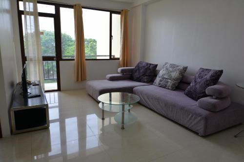 a living room with a couch and a table at BALAI Condominiums in Lusong