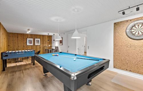 a room with a pool table and a clock at Stunning Home In Roslev With Sauna in Glyngøre