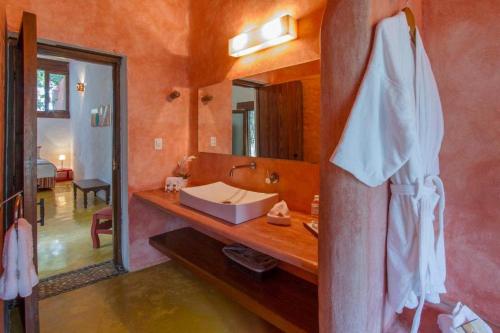 a bathroom with a sink and a mirror at Hacienda Santa Cruz Merida in Mérida